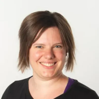 Megan Wilson smiling in a black shirt.