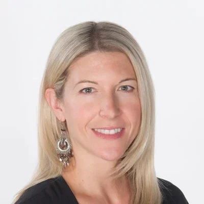 Alana smiling in a black shirt.