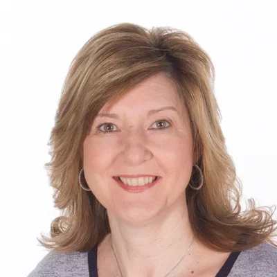 Holly smiling in a grey shirt.