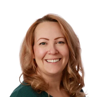 Miranda smiling in a green shirt.