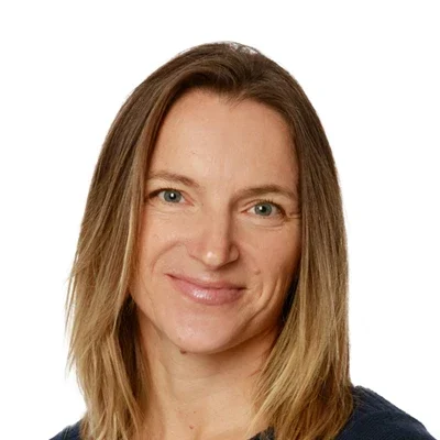 Sabine Hagen smiling in a blue sweater.